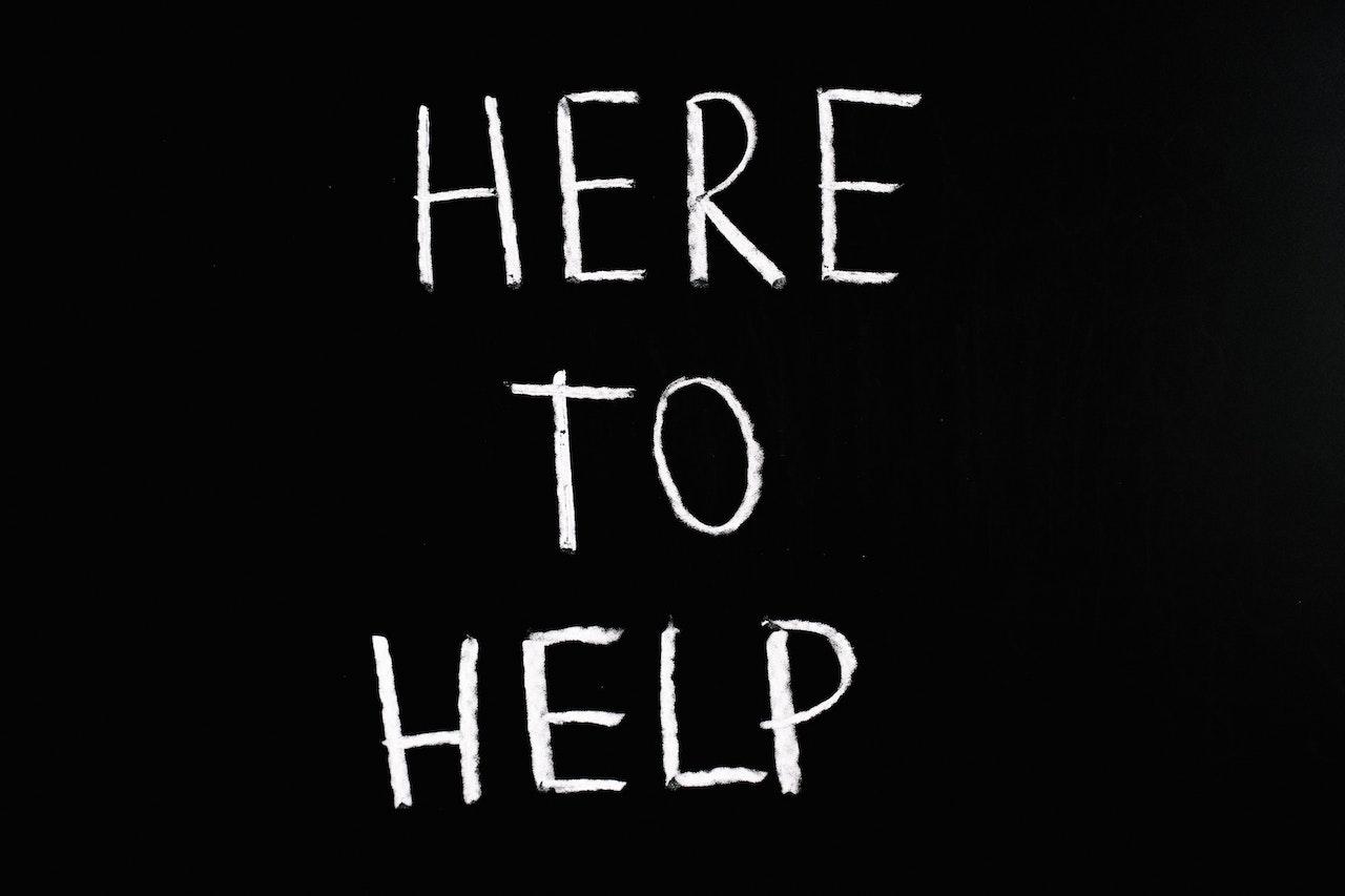 black background with “here to help” in white letters
